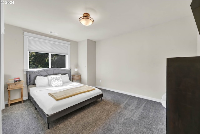 bedroom with dark colored carpet