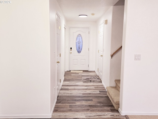 doorway featuring hardwood / wood-style floors and a textured ceiling