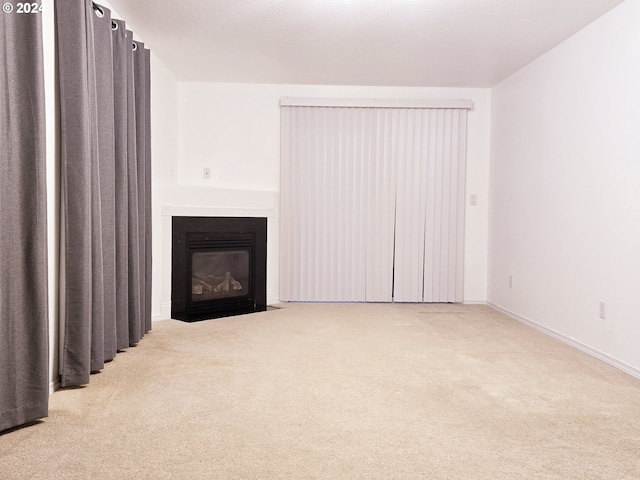 unfurnished living room with carpet