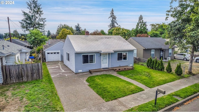 bungalow-style home featuring a garage and a front lawn