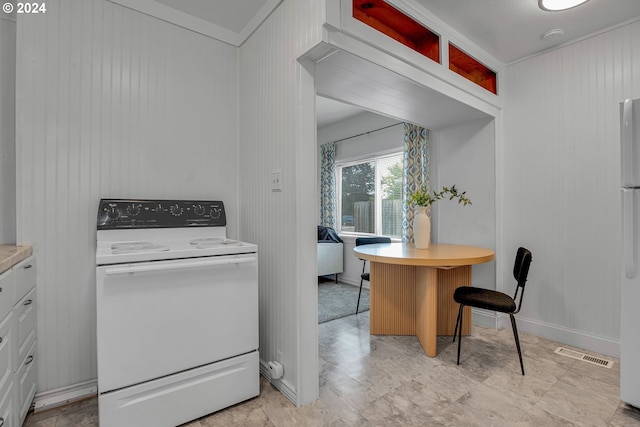 kitchen with wood walls and white stove