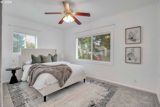 carpeted bedroom with ceiling fan and crown molding