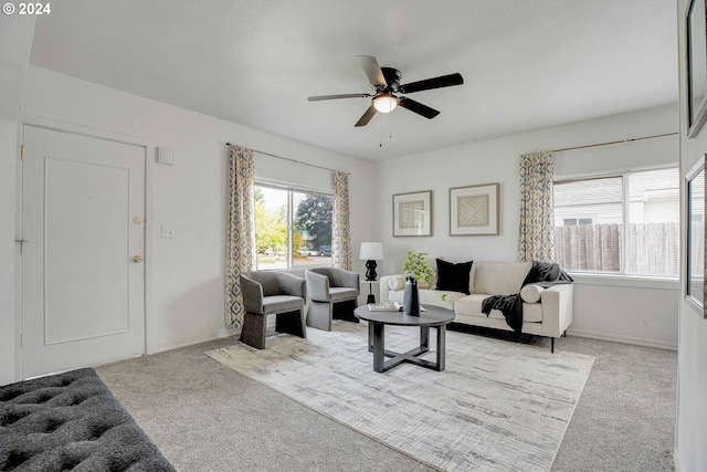 carpeted living room featuring ceiling fan