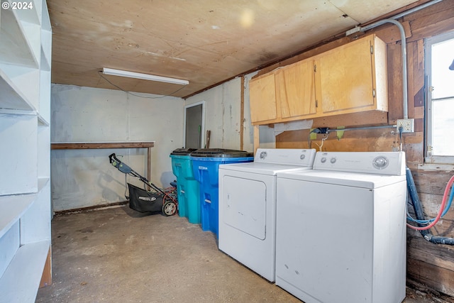 clothes washing area with cabinets and independent washer and dryer