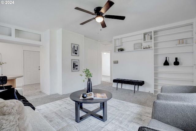 living room featuring light carpet and ceiling fan