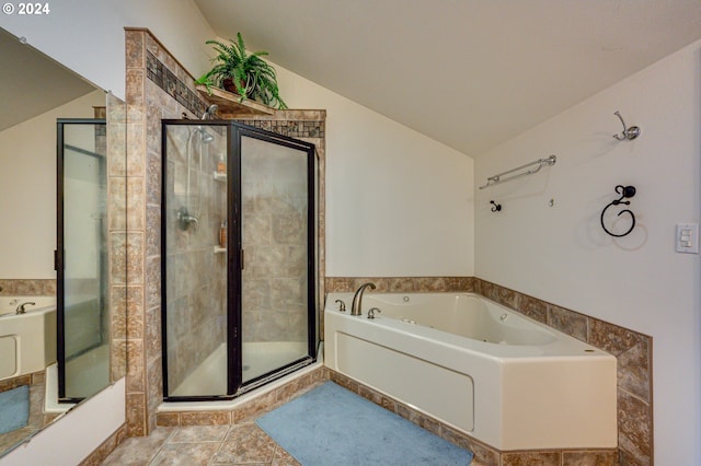 bathroom featuring tile patterned flooring, independent shower and bath, and lofted ceiling