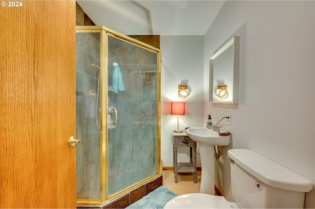 bathroom featuring toilet and an enclosed shower