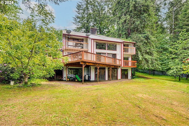 back of house with a yard and a wooden deck