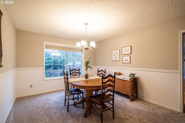 carpeted dining space with a textured ceiling and a notable chandelier