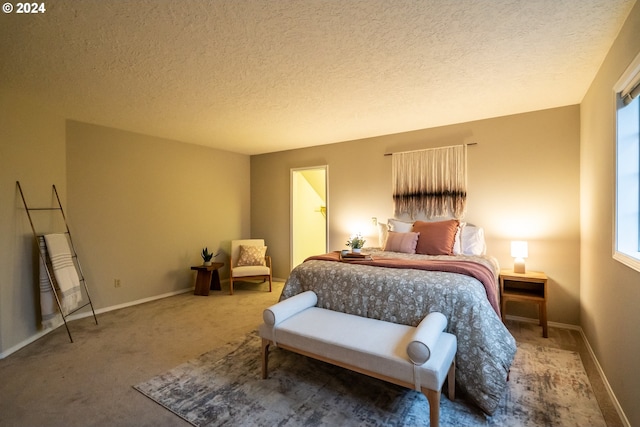 bedroom featuring carpet and a textured ceiling