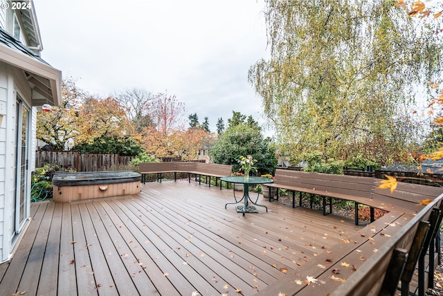 wooden terrace featuring a covered hot tub