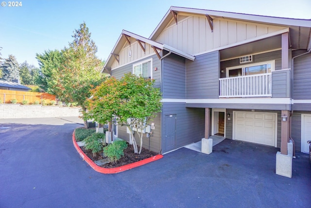 view of front of property with a balcony and a garage