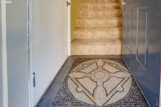 staircase with tile patterned floors