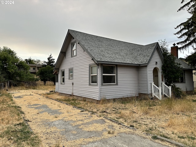 view of property exterior featuring roof with shingles