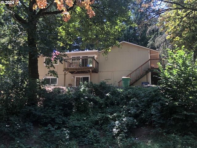 back of house featuring a balcony