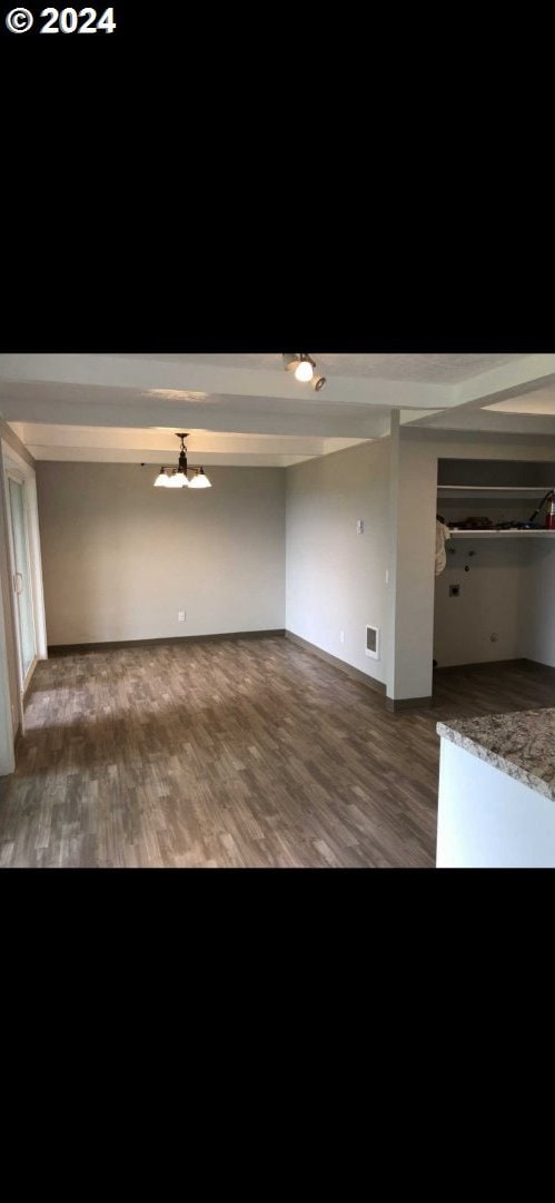 unfurnished living room featuring dark wood-type flooring