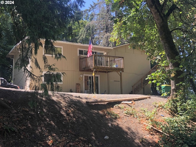 back of house featuring a wooden deck