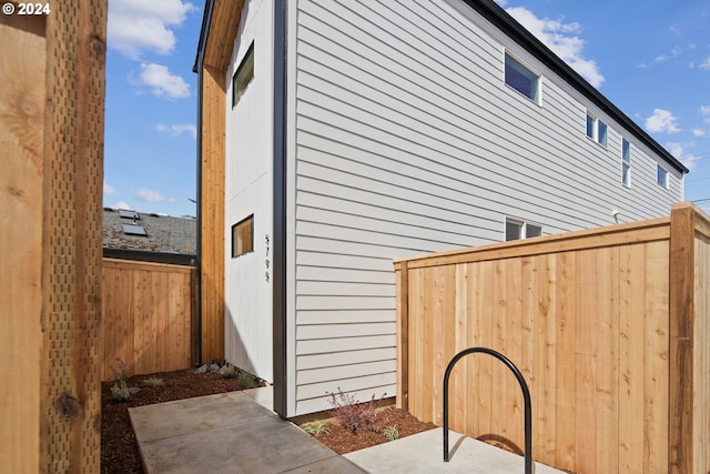 view of side of home with a patio and fence