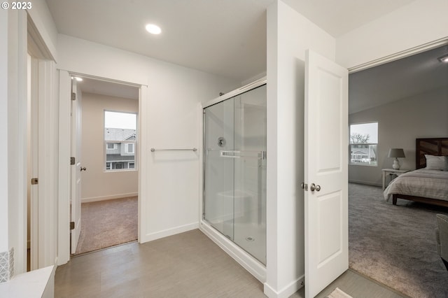 bathroom with wood-type flooring and a shower with shower door