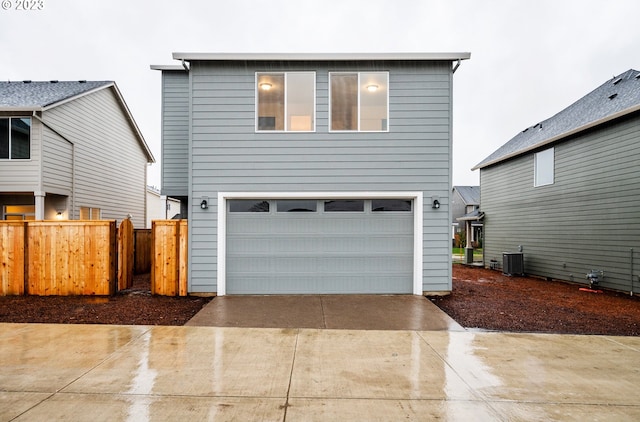 view of front property with cooling unit and a garage