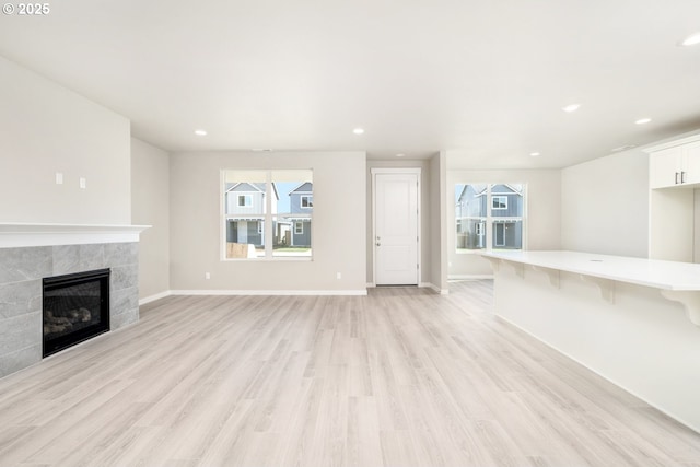 3104 S Kodiak St Unit Lt814, Cornelius, OR 97113 - unfurnished living room with plenty of natural light, light wood-style floors, a tile fireplace, and recessed lighting