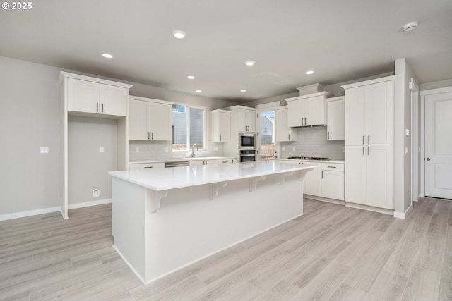 3104 S Kodiak St Unit Lt814, Cornelius, OR 97113 - kitchen featuring appliances with stainless steel finishes, a large island, white cabinetry, decorative backsplash, and recessed lighting