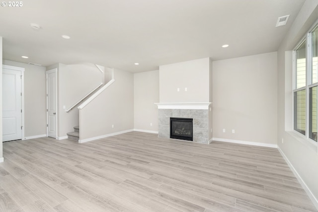 3104 S Kodiak St Unit Lt814, Cornelius, OR 97113 - unfurnished living room with light wood-style flooring, recessed lighting, stairway, and a tile fireplace