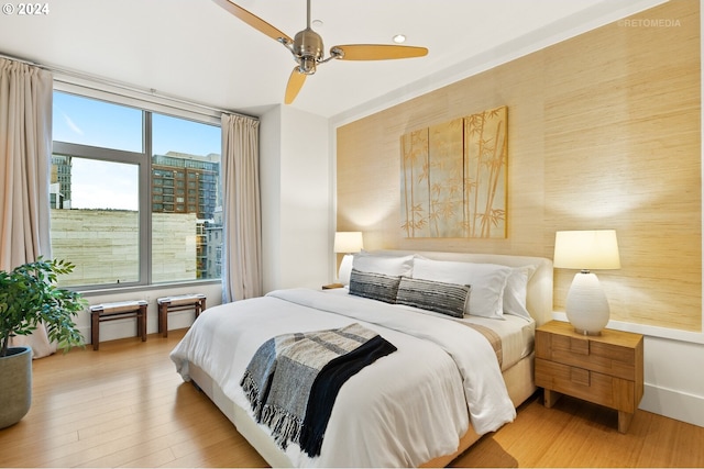 bedroom featuring wood-type flooring and ceiling fan