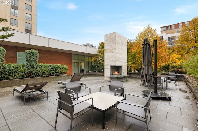 view of patio / terrace with an outdoor stone fireplace