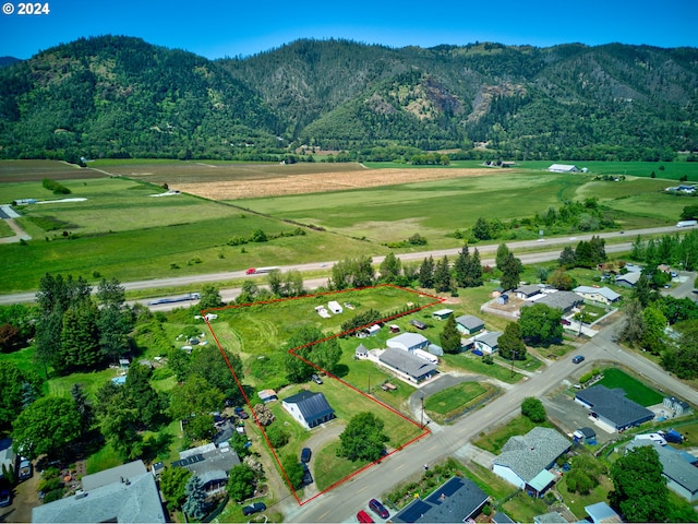 bird's eye view featuring a mountain view, a rural view, and a wooded view