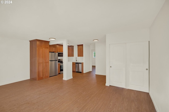 unfurnished living room with hardwood / wood-style floors