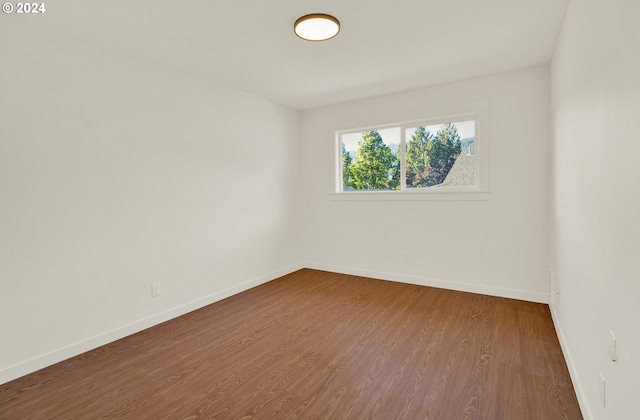 spare room with hardwood / wood-style floors