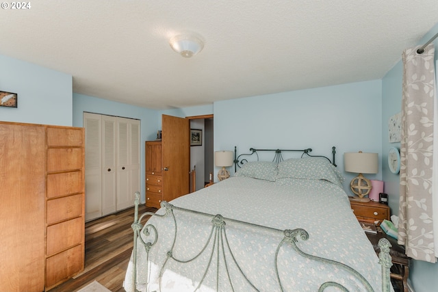 bedroom with a closet and hardwood / wood-style flooring