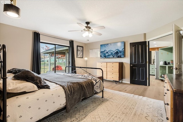 bedroom featuring ceiling fan, a textured ceiling, and light hardwood / wood-style flooring