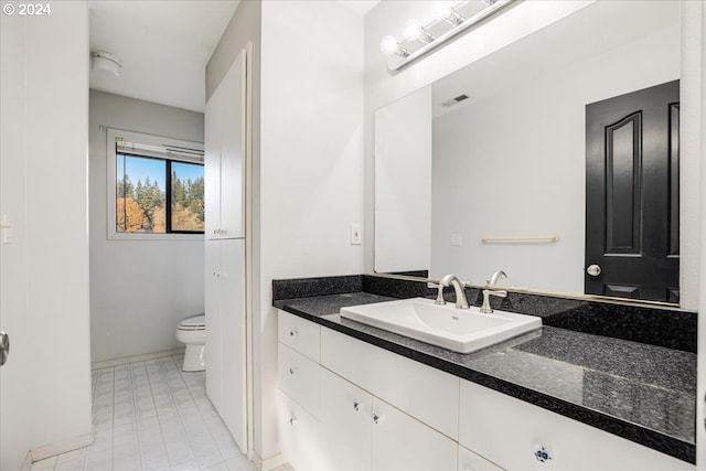 bathroom with toilet and vanity