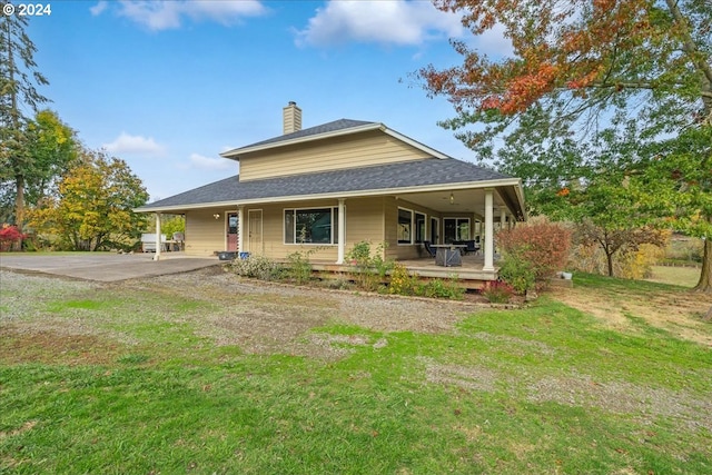 back of house with a lawn