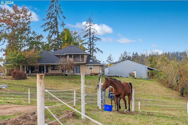 view of horse barn with a rural view