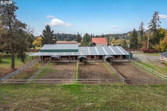 back of house with an outbuilding and a rural view