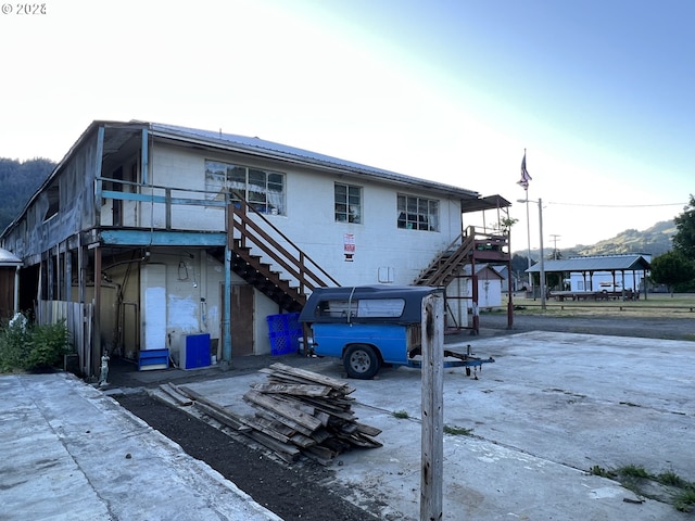 432 2nd Ave, Powers, OR 97466 - view of front of house with stairs, concrete block siding, and a wooden deck