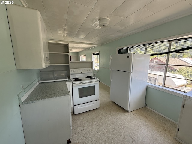 432 2nd Ave, Powers, OR 97466 - kitchen featuring white appliances, baseboards, open shelves, and white cabinetry