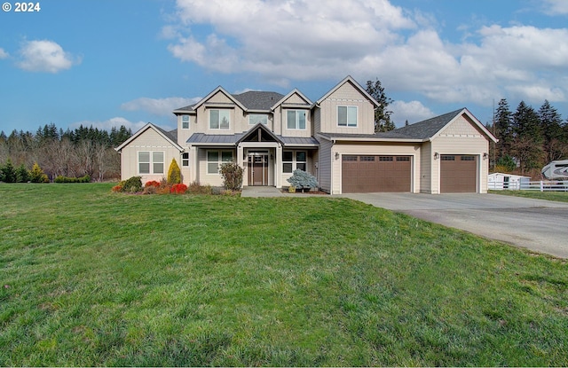 view of front of house with a front yard and a garage