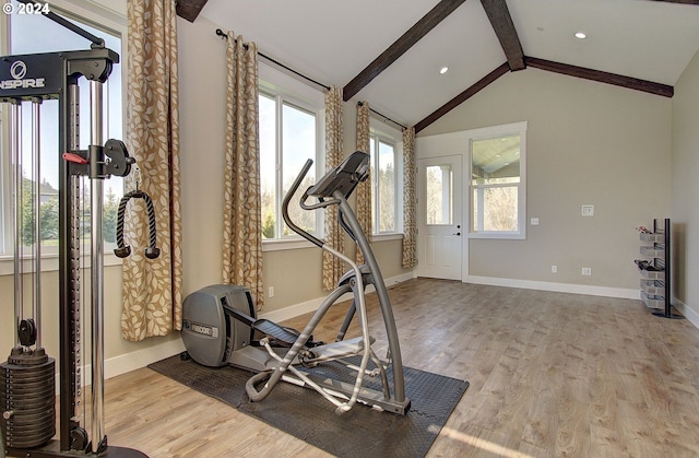 exercise area with light hardwood / wood-style floors and lofted ceiling