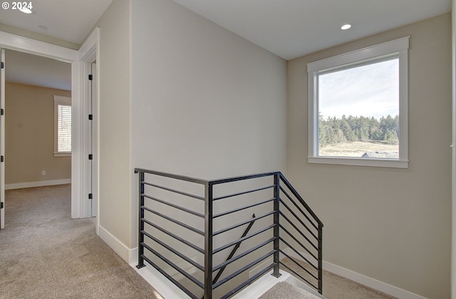 hallway featuring carpet flooring and a wealth of natural light