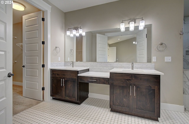 bathroom featuring vanity and backsplash