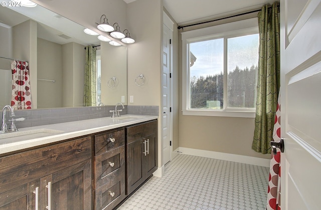 bathroom featuring vanity and backsplash