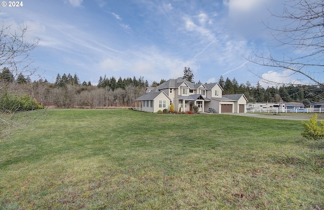 cape cod-style house featuring a front yard and a garage