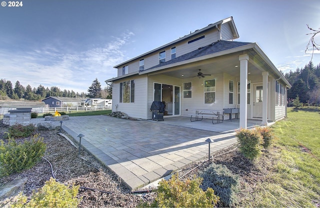 back of property featuring ceiling fan and a patio area