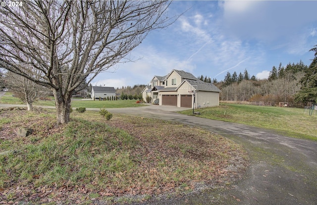 exterior space featuring a garage and a lawn