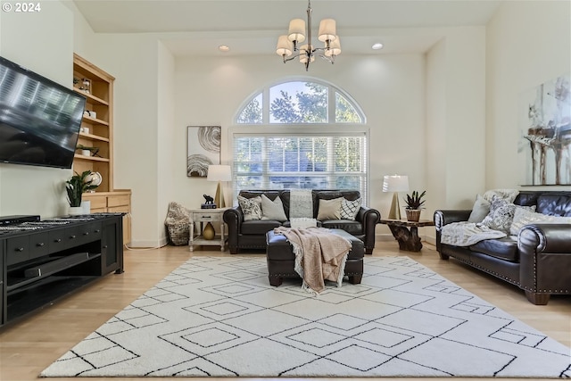 living room with a notable chandelier and light hardwood / wood-style flooring