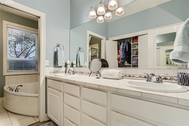 bathroom with tile patterned flooring, vanity, and a washtub